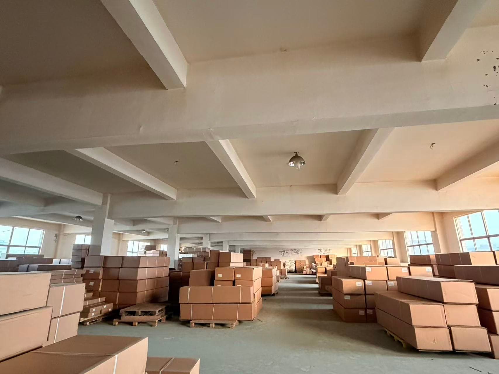 Warehouse hall with stacks of packed cartons and pallets